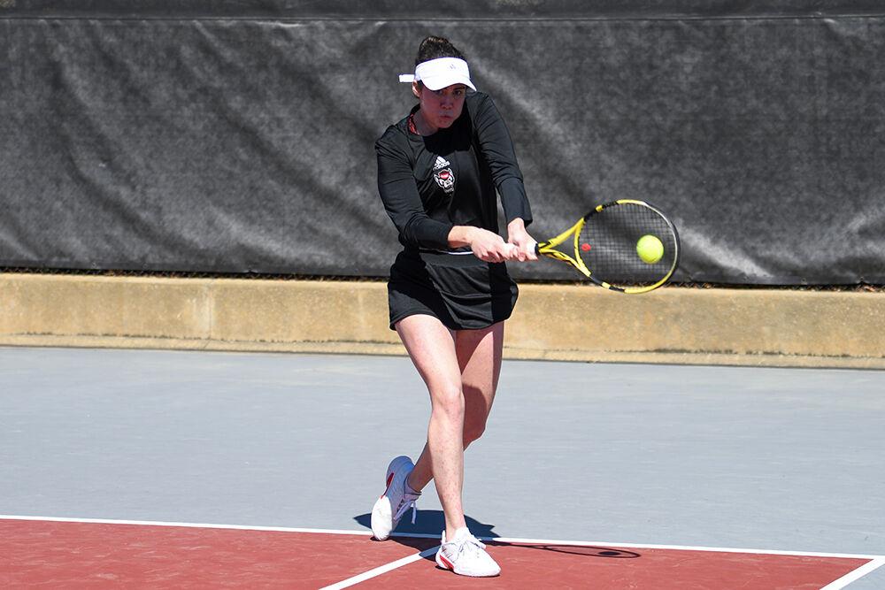 Graduate Nell Miller completes a forehand swing in her doubles match against Clemson at the Dail Outdoor Tennis Stadium on Sunday, March 5, 2023. Miller and junior Amelia Rajecki won their doubles match 6-2. The Wolfpack beat the Tigers 6-1.