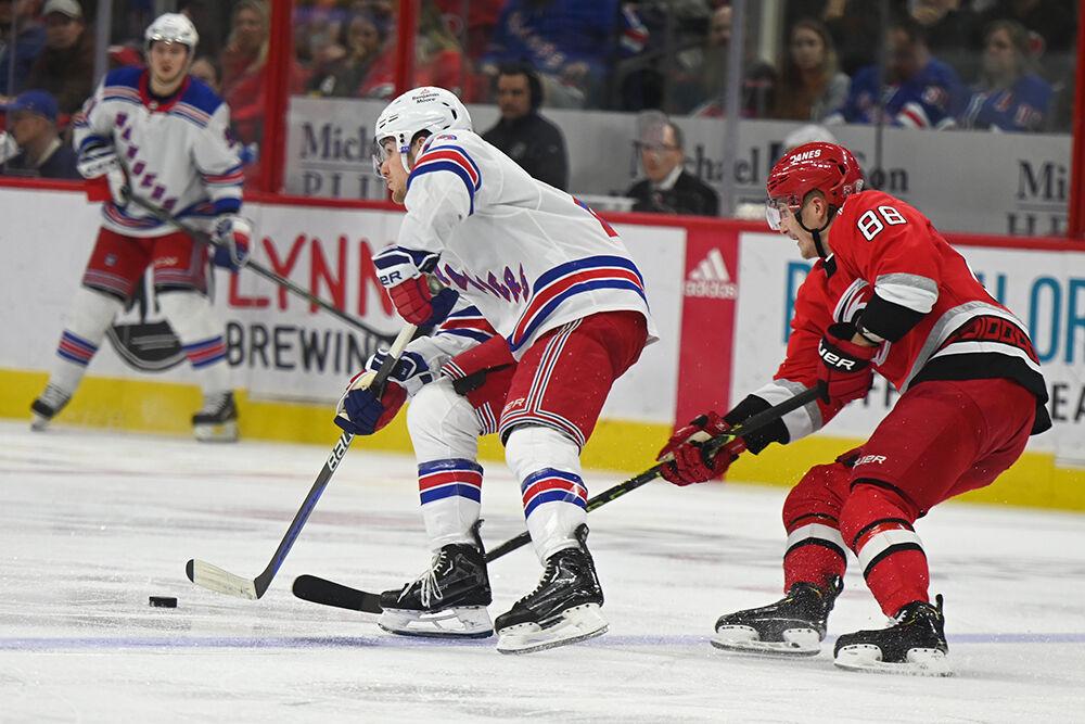 Carolina Hurricanes center Martin Necas defends a New York Ranger opponent in PNC Arena on Thursday, March 23, 2023. The Hurricanes lost 2-1.