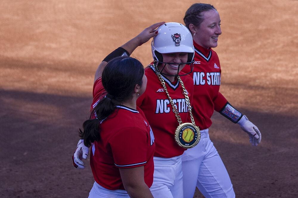 (From left) Freshman catcher Amanda Hasler, graduate outfielder Rebecca Murray and freshman outfielder Ellie Goins celebrate a run during the game against North Carolina A&amp;T at Dail Softball Stadium on Wednesday, March 29, 2023. NC State won 8-2.