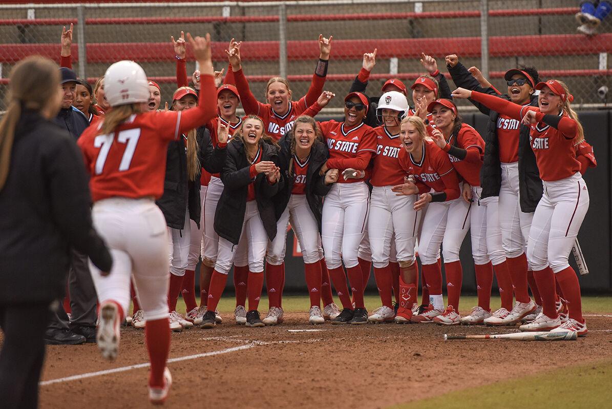 The softball team cheers on sophomore infielder Hannah Goodwin after her home run during the game against the Radford Highlanders in Dail Softball Stadium on Wednesday, March 22, 2023. The Wolfpack beat the Highlanders 8-7.