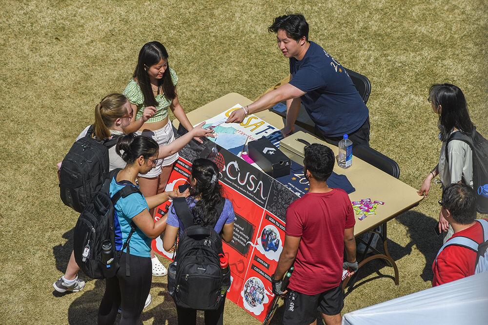 Students gather around the table for the Chinese Undergraduate Student Association during the NC State International Festival in Stafford Commons on Friday, March 24, 2023. Booths were hosted by various cultural student associations and groups to provide information and on-campus resources to students.