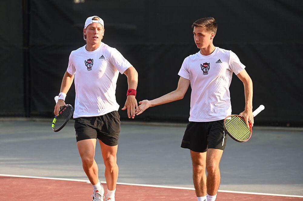 Sophomore Fons Van Sambeek (left) and redshirt sophomore Braden Shick celebrate after winning a game against Notre Dame at Dail Outdoor Tennis Stadium on Friday, March 24, 2023. Van Sambeek and Shick swept their doubles match 6-0. NC State beat Notre Dame 4-0.