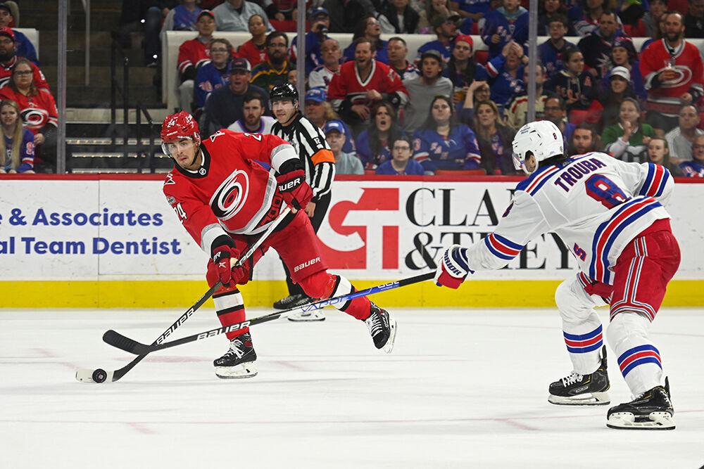 Carolina Hurricanes center Seth Jarvis passes the puck during the game against the New York Rangers in PNC Arena on Thursday, March 23, 2023. The Hurricanes lost 2-1.