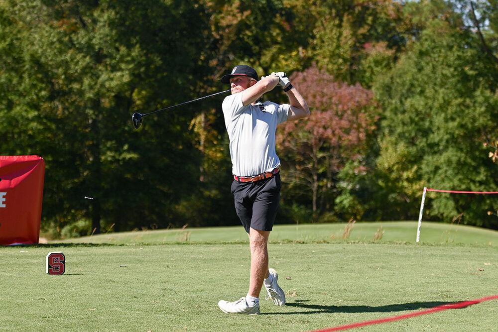 Senior Carter Graf drives the golf ball during the Wolfpack Intercollegiate at the Lonnie Poole Golf Course on Saturday, Oct. 15, 2022. Graf came in 14th place during the tournment and was one-under par. NC State tied for second.