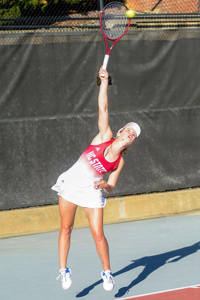 Junior Gina Dittmann lunges at the ball during her singles match against East Tennessee State at the Dail Outdoor Tennis Stadium on Sunday, March 5, 2023. Dittmann won her singles match 2-0. NC State beat ETSU 7-0.