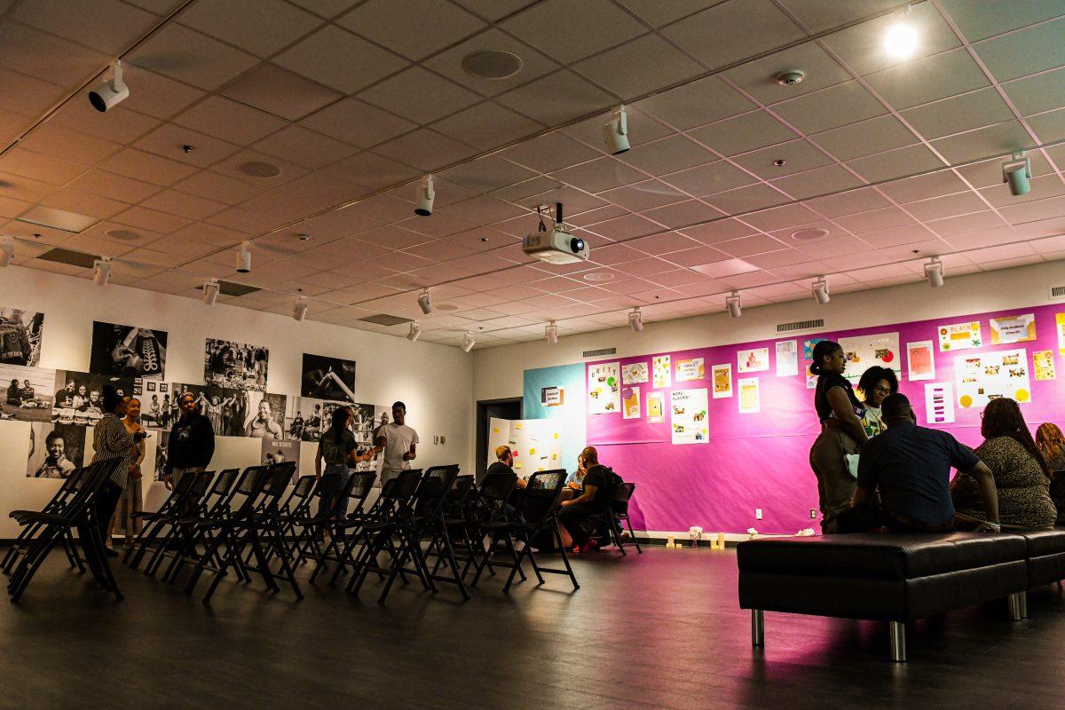 Students view the scrapbook gallery and create their own entries at the gallery opening for Black Euphoria: Love Letters to Black Life at Witherspoon Student Center on Tuesday, Feb. 28, 2023. The event praised euphoria in black lives and accomplishments; it showcased scrapbooks that students and staff made to document and reflect views of Black euphoria.