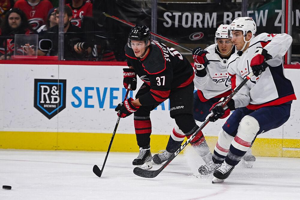 Carolina Hurricanes right wing Andrei Svechnikov races to the puck alongside a Washington Capitals opponent during the game on Monday, Oct. 31, 2022 in PNC Arena. The Hurricanes beat the Capitals 3-2.