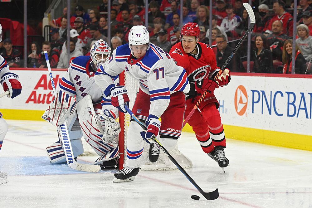Carolina Hurricanes right wing Jesse Puljujarvi defends a New York Ranger opponent in PNC Arena on Thursday, March 23, 2023. The Hurricanes lost 2-1.