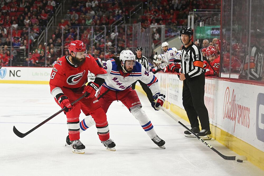 Carolina Hurricanes defenseman Brent Burns defends a New York Ranger opponent in PNC Arena on Thursday, March 23, 2023. The Hurricanes lost 2-1.