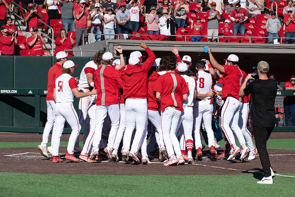 Members of the NC State baseball team celebrate the walk-off win against NJIT at Doak Field at Dail Park on Sunday, March 5, 2023. Sophomore infielder Payton Green hit a home run to secure the win. NC State won 6-5 and swept the series.&#160;