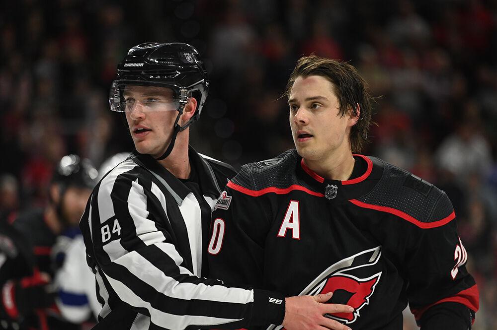 A referee holds back Carolina centreman Sebastian Aho during the Hurricanes' home game against the Tampa Bay Lightning in PNC Arena on Tuesday, March 28, 2023. The Lightning beat the Canes 4-0.