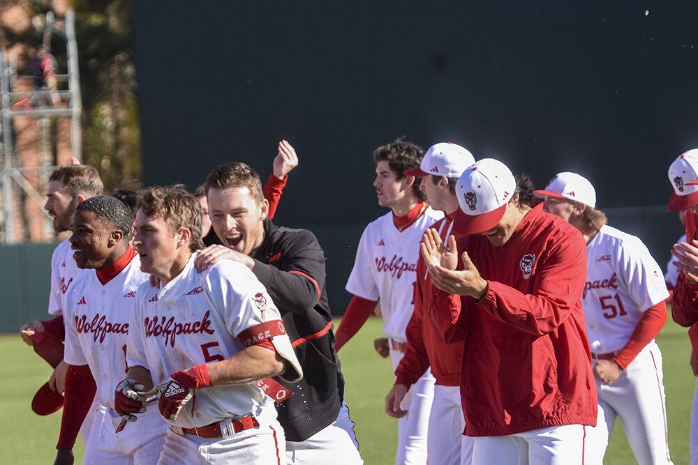 Members of the NC State baseball team celebrate freshman catcher Cannon Peebles' walk-off single against the University of Virginia at Doak Field at Dail Park on Saturday, March 18, 2023. Peebles scored one run. NC State beat UVA 5-4.