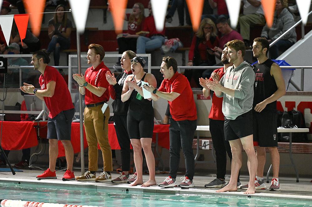 Members of the Wolfpack swim and dive team cheer on their teammates during the meet against the UNC-Wilmington Seahawks at the Willis R. Casey Aquatics Center on Friday, Jan. 27, 2023. The Wolfpack men beat the Seahawks 160-126 and women beat the Seahawks 186-105.