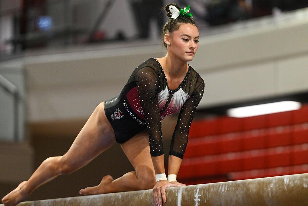 Senior Emily Shepard poses during her routine on the balance beam during the meet against New Hampshire in Reynolds Coliseum on Friday, Feb. 17, 2023. Shepard finished the meet scoring third overall with a score of 39.075. NC State beat New Hampshire with a final score of 196.150.