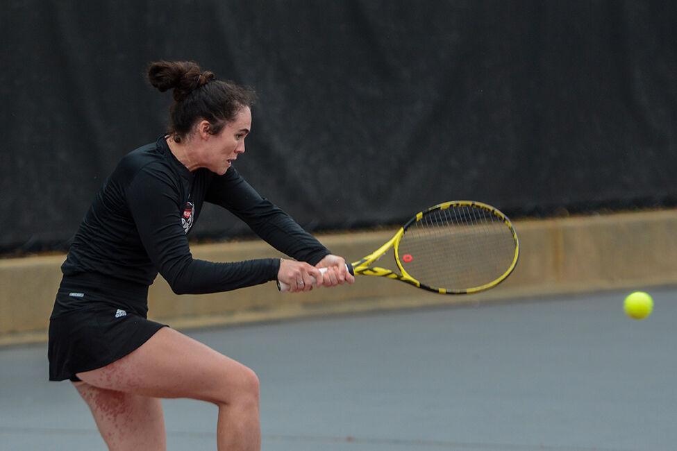 Graduate Nell Miller forehands the ball in her doubles match against East Carolina University at the Dail Outdoor Tennis Stadium on Friday, March 31, 2023. The Wolfpack beat ECU 7-0.