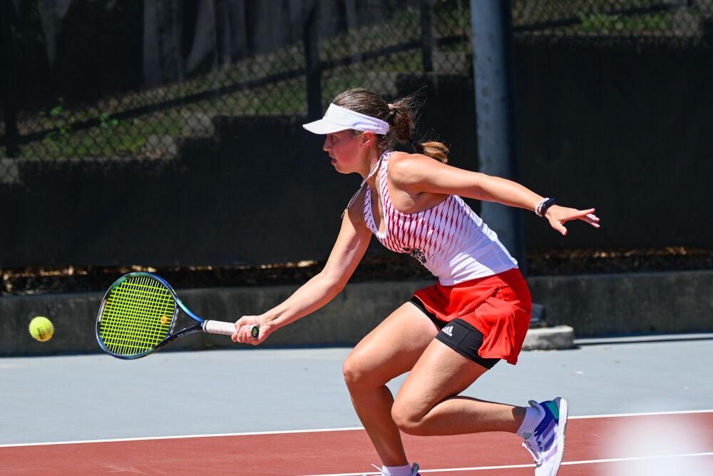 Freshman Anna Zyryanova goes up for the ball during her singles match at J.W. Isenhour Tennis Center on Sunday, April 2, 2023. Zyryanova won her singles match. NC State beat Boston College 7-0.