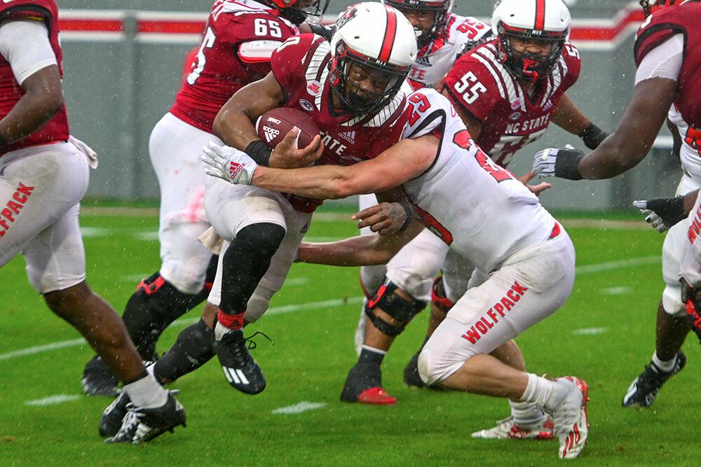 Junior running back Demie Sumo-Karngbaye runs through a wall of players during the spring game at Carter-Finley Stadium on Saturday,&#160;April 8, 2023. The Red team beat the White team 41-10.