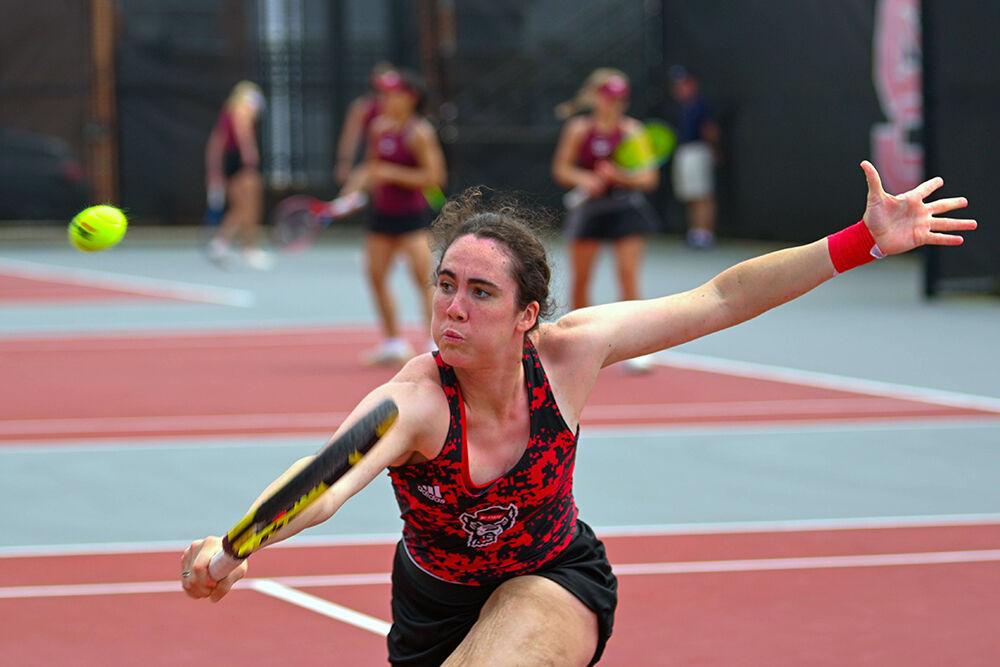 Graduate Nell Miller takes a swing at the ball during the match against Virginia Tech at&#160;Dail Outdoor Tennis Stadium on Sunday, April 16, 2023. Miller won her singles match. NC State beat Virginia Tech 7-0.