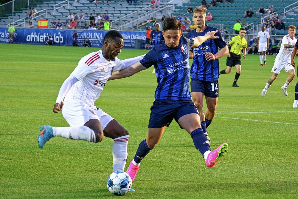 North Carolina FC defender Nelson Flores Blanco attempts to steal the ball from his opponent during the game against the Chattanooga Red Wolves at&#160;Sahlen's Stadium in WakeMed Soccer Park on Friday, April 21, 2023. NCFC beat the Chattanooga Red Wolves 3-0.