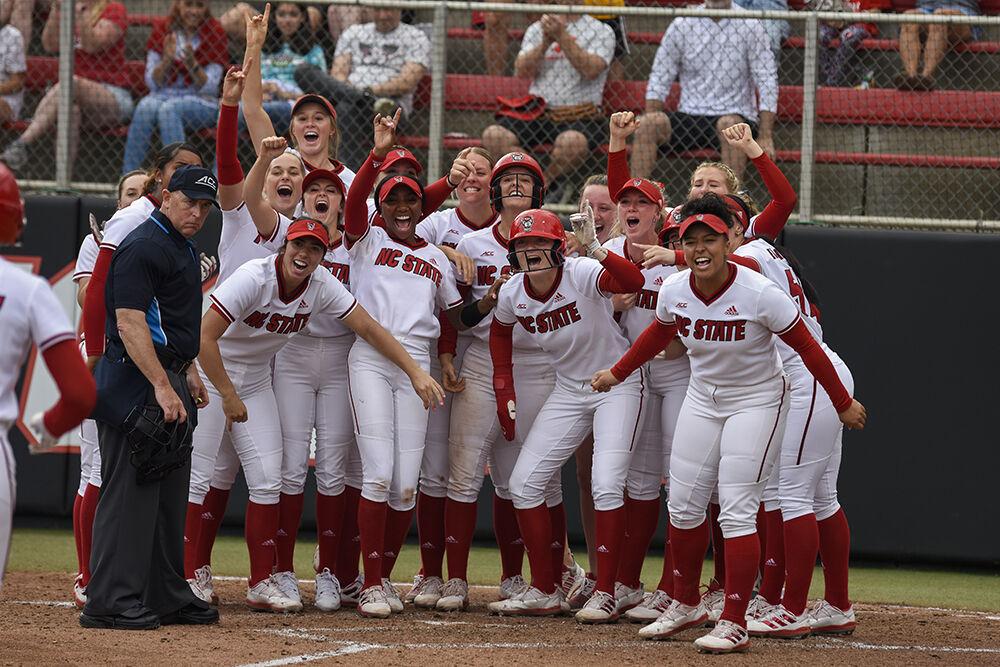 Members of the NC State softball team cheer on their players as they run to home base during the game against Clemson at Dail Softball Stadium on Sunday, April 16, 2023. NC State beat Clemson 7-5.
