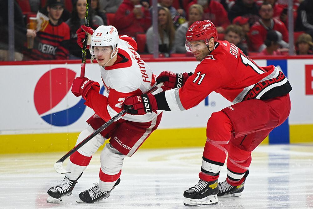 Carolina Hurricanes center Jordan Staal defends Detroit Red Wings opponent in PNC Arena on Tuesday, April 11, 2023. The Hurricanes won 4-1.