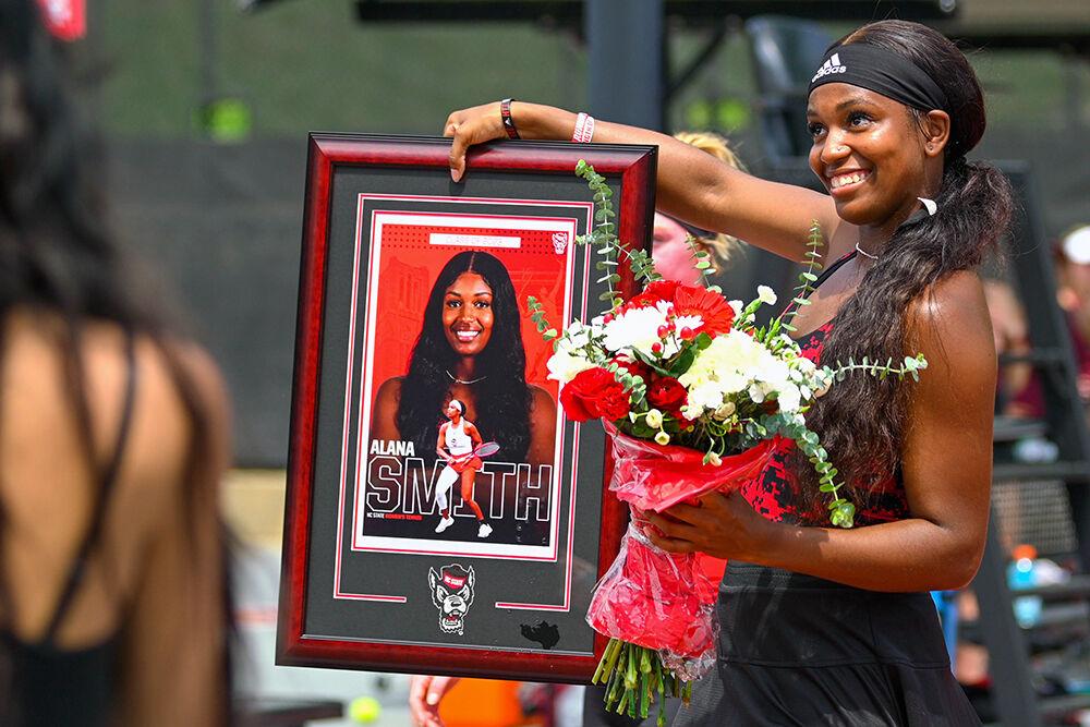 Graduate Alana Smith shows off her new plaque before the match against Virginia Tech at Dail Outdoor Tennis Stadium on Sunday, April 16, 2023. Smith won her doubles and singles match. NC State beat Virginia Tech 7-0.