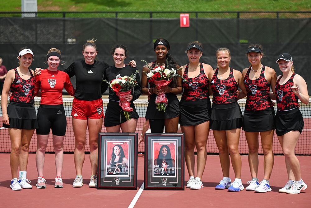 The NC State women's tennis team poses for a photo with seniors Nell Miller and Alana Smith in celebration of senior day during the match against Virginia Tech at Dail Outdoor Tennis Stadium on Sunday, April 16, 2023. NC State beat Virginia Tech 7-0.