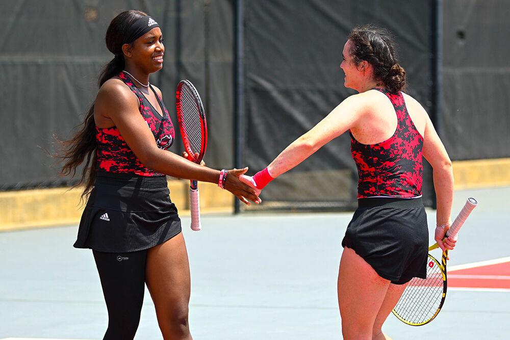 Graduate Alana Smith and graduate Nell Miller high-five after gaining a point during the match against Virginia Tech at&#160;Dail Outdoor Tennis Stadium on Sunday, April 16, 2023. Smith and Miller won their doubles match 5-2. NC State beat Virginia Tech 7-0.