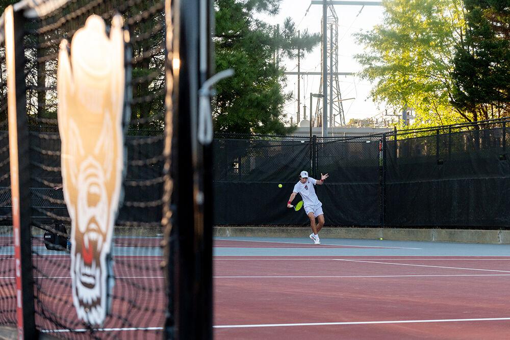 Sophomore Joseph Wayand backhands the ball during the match against Wake Forest at Dail Outdoor Tennis Stadium on Wednesday, April 12, 2023. Wayand won both his singles and doubles matches. NC State beat Wake Forest 4-2.