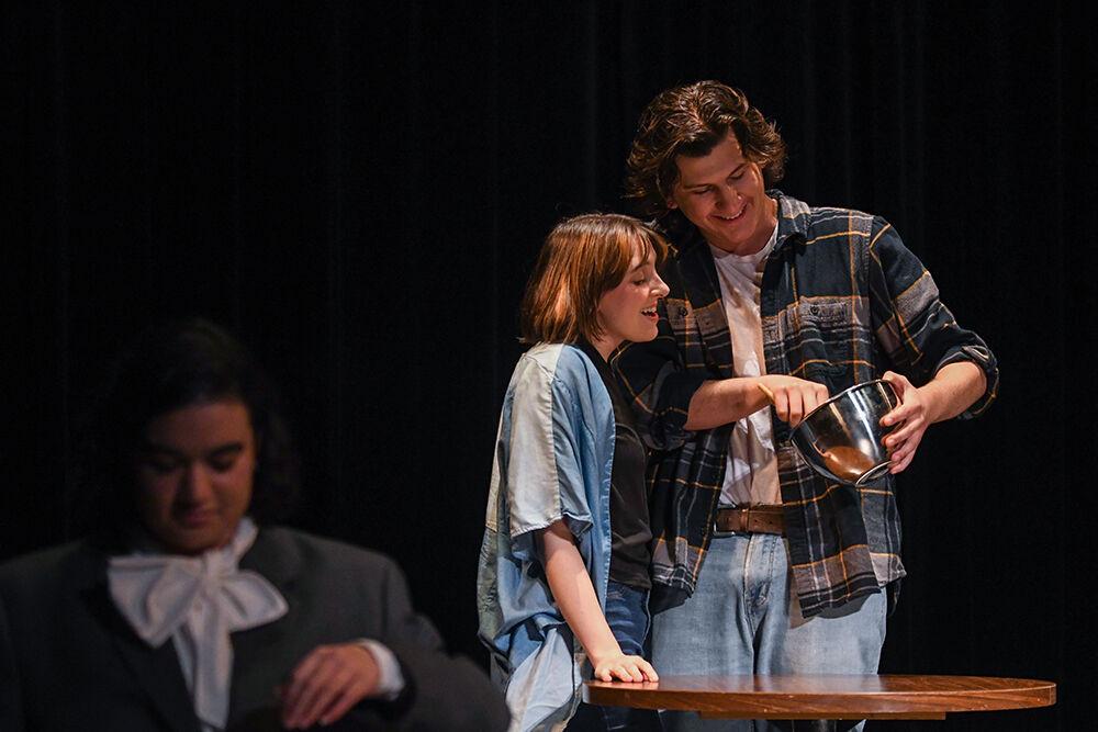Mary Margaret Hanna (left), a graduate student studying English, as Eurydice makes brownies with Will Godby (right), a fourth-year studying psychology, as Finn during the performance of "Muse" inside Kennedy-McIlwee Studio Theatre on Wednesday, March 29, 2023. "Muse," written by Gaven Bell, a fourth-year studying biological sciences, won the Arts NC State Creative Artist Award.