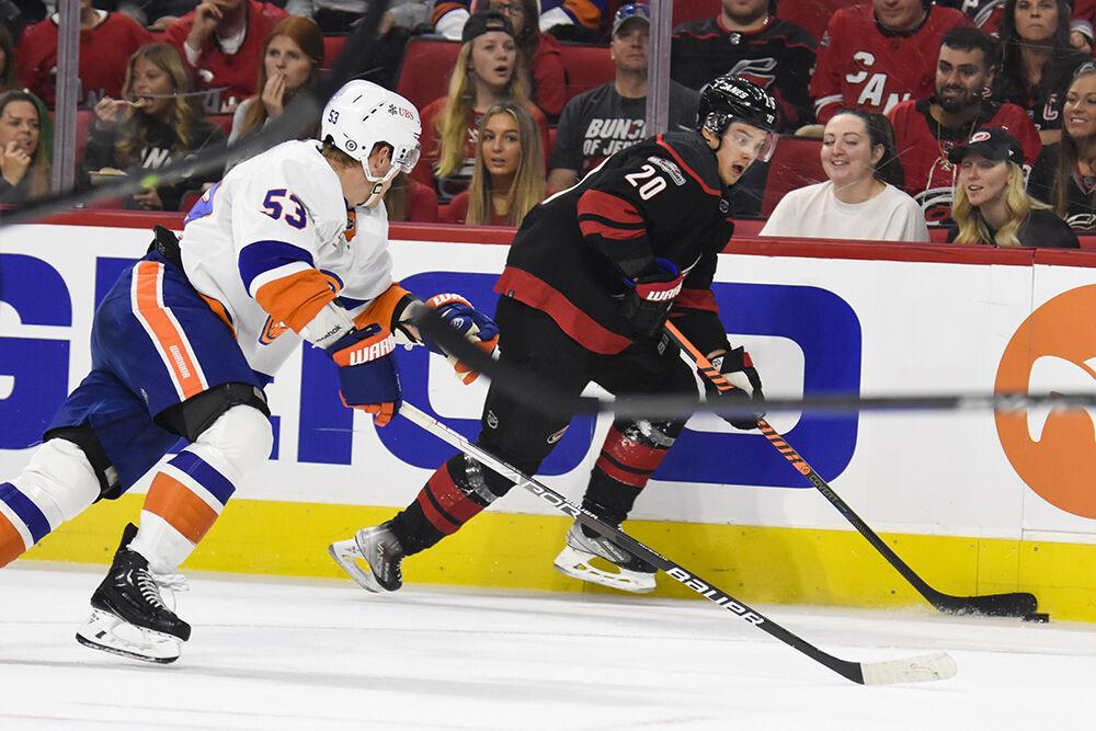 Carolina Hurricanes center Sebastian Aho dribbles the puck up ice away from an&#160; opponent during the game against the New York Islanders in PNC Arena on Sunday, April 2, 2023. Aho had three shots on goal throughout the game. The Hurricanes won 2-1.