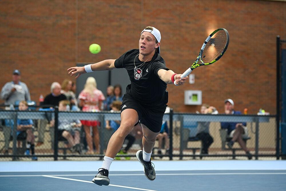 Sophomore Fons Van Sambeek reaches for the ball during the away tennis match against UNC-Chapel Hill at the Cone-Kenfield Tennis Center on Friday, March 31, 2023. NC State beat UNC 4-1.