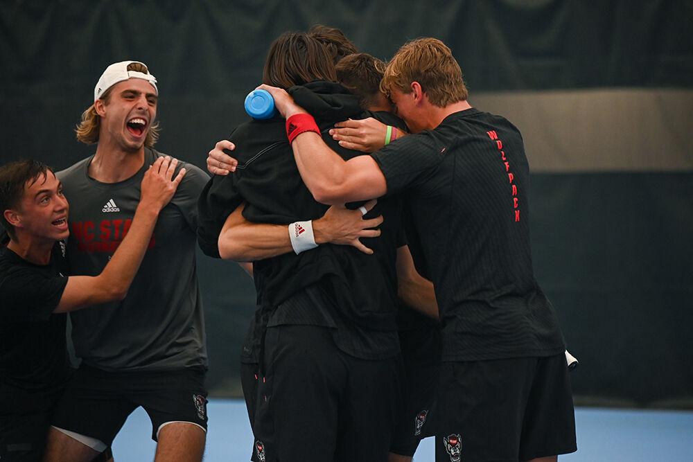The NC State men's tennis team celebrates a win after the away tennis match against UNC-Chapel Hill at the Cone-Kenfield Tennis Center on Friday, March 31, 2023. NC State beat UNC 4-1.