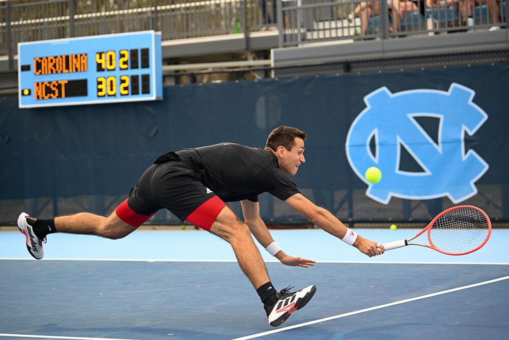 Junior Luca Staeheli swings for the ball during the away tennis match against UNC-Chapel Hill at the Cone-Kenfield Tennis Center on Friday, March 31, 2023. Staeheli won his singles match. NC State beat UNC 4-1.