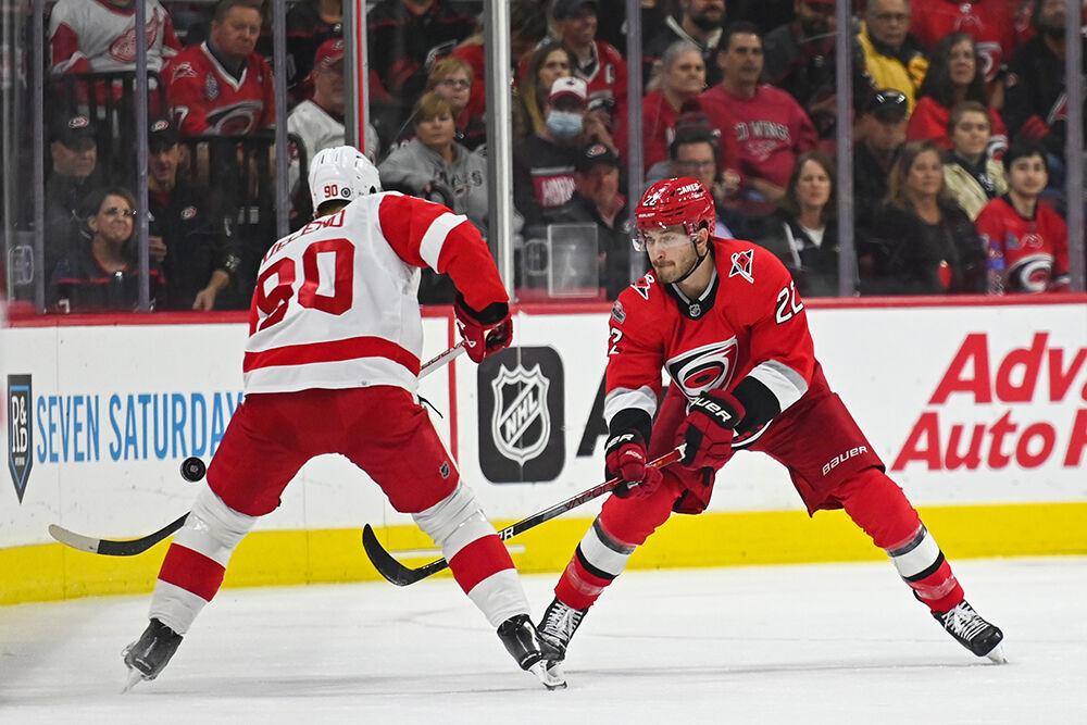 Carolina Hurricanes defenseman Brett Pesce defends a Detroit Red Wings opponent in PNC Arena on Tuesday, April 11, 2023. The Hurricanes won 4-1.