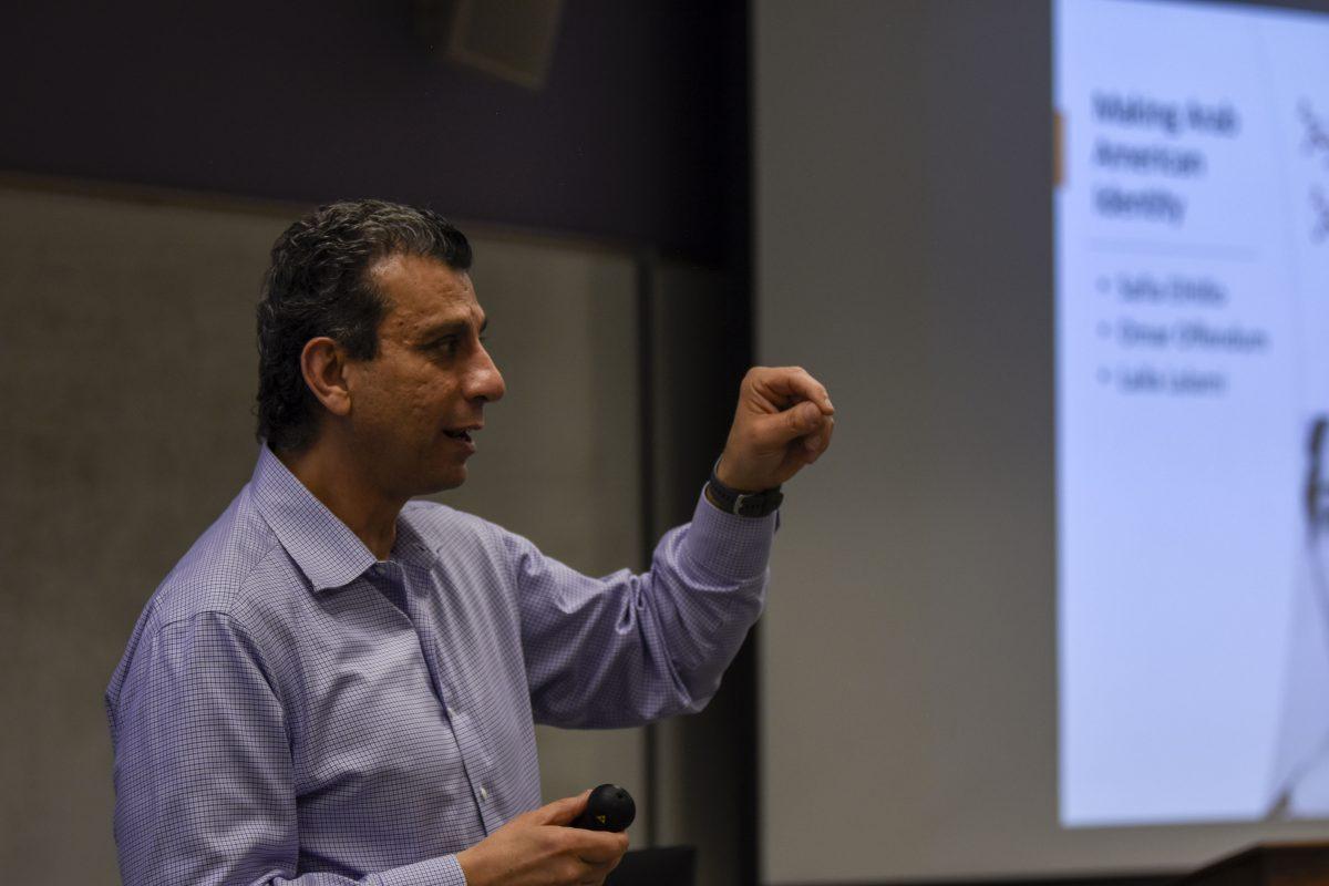 Akram Khater, professor in the department of History, illustrates the adversity many Arab imigrants experienced in their immigration to the United States during the History of Arabs in America HIStalk at Withers Hall on Wednesday, April 12., 2023.