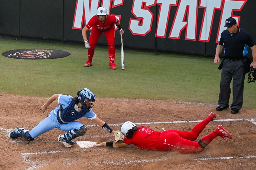 Freshman catcher Amanda Hasler dives for home plate during the game against UNC-Chapel Hill at Dail Softball Stadium on Friday, April 21, 2023. Hassler scored one run. NC State lost to the Tar Heels 5-4.