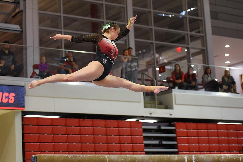 Senior gymnast Chloe Negrete performs a split leap on the beam during the meet against New Hampshire at Reynolds Coliseum on Friday, Feb. 17, 2023. Negrete earned a score of 9.850 and finished first in the event. NC State beat New Hampshire with an overall score of 196.150.