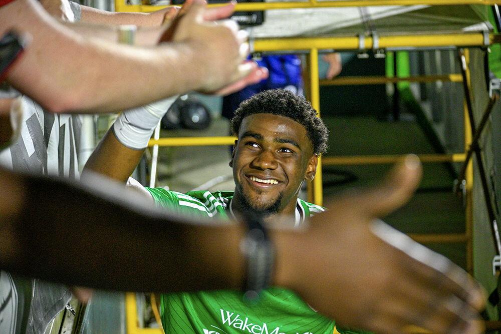 North Carolina FC goalkeeper Nicholas Holliday high-fives fans after the win against the Chattanooga Red Wolves at Sahlen's Stadium in WakeMed Soccer Park on Friday, April 21, 2023. Holliday made several blocks against the Chattanooga Red Wolves. NCFC beat the Chattanooga Red Wolves 3-0.