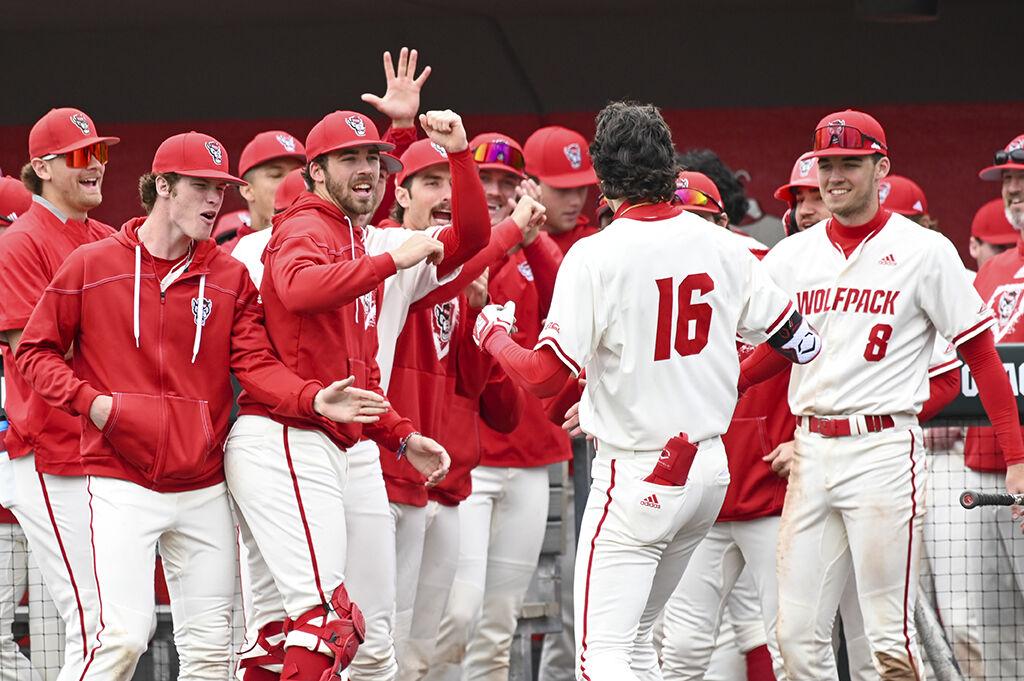Members of the NC State baseball team celebrate freshman infielder/outfielder Eli Serrano hitting a home run during the game against Belmont at Doak Field at Dail Park on Sunday, Feb. 26, 2023. NC State beat Belmont 7-1 to sweep the series.