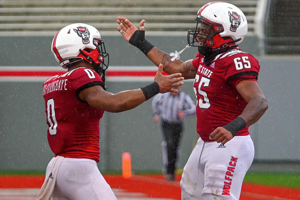 Junior running back Demie Sumo-Karngbaye (left) and redshirt freshman Jacarrius Peak (right) celebrate after a touchdown during the spring game at Carter-Finley Stadium on Saturday,&#160;April 8, 2023. The Red team beat the White team 41-10.