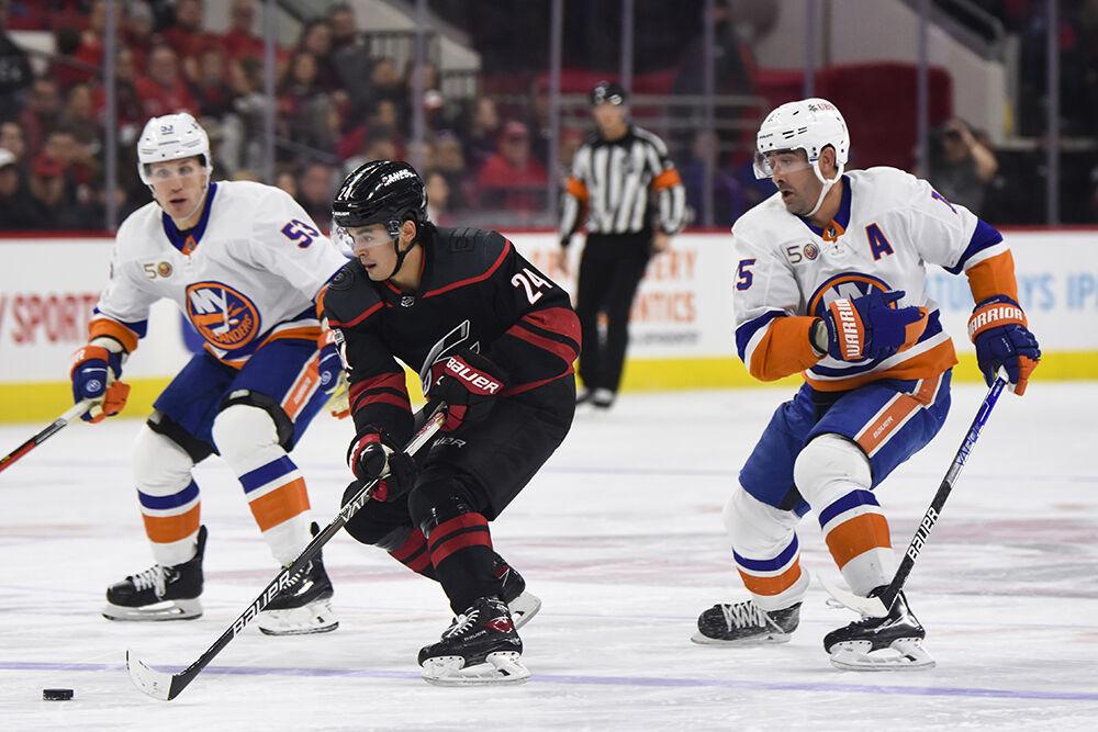 Carolina Hurricanes center Seth Jarvis dribbles the puck up ice away from an opponent during the game against the New York Islanders in PNC Arena on Sunday, April 2, 2023. Jarvis had one shot on goal throughout the game. The Hurricanes won 2-1.