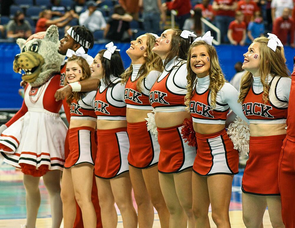 The NC State Cheerleaders lock arms and sing after the semi-final game of the Women's ACC Tournament versus the Virginia Tech Hokies on Saturday, March 5, 2022 in the Greensboro Coliseum. The Wolfpack beat the Hokies 70-55.