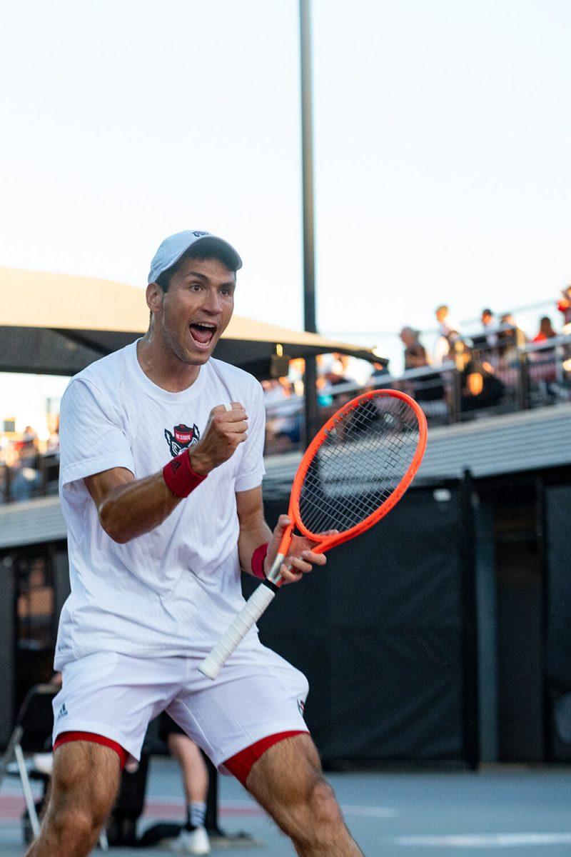 Junior Luca Staeheli celebrates after scoring a point during the match against Wake Forest at Dail Outdoor Tennis Stadium on Wednesday, April 12, 2023. Staeheli won his doubles match and his singles match went unfinished. NC State beat Wake Forest 4-2.