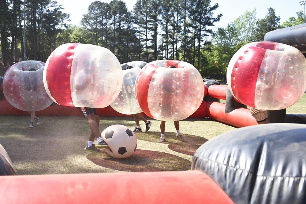 Students battle each other in bubble soccer during the Wolfstock Festival on Miller Field on Monday, April 25, 2022. Wolfstock was an all-day festival and concert hosted on the last day of classes.