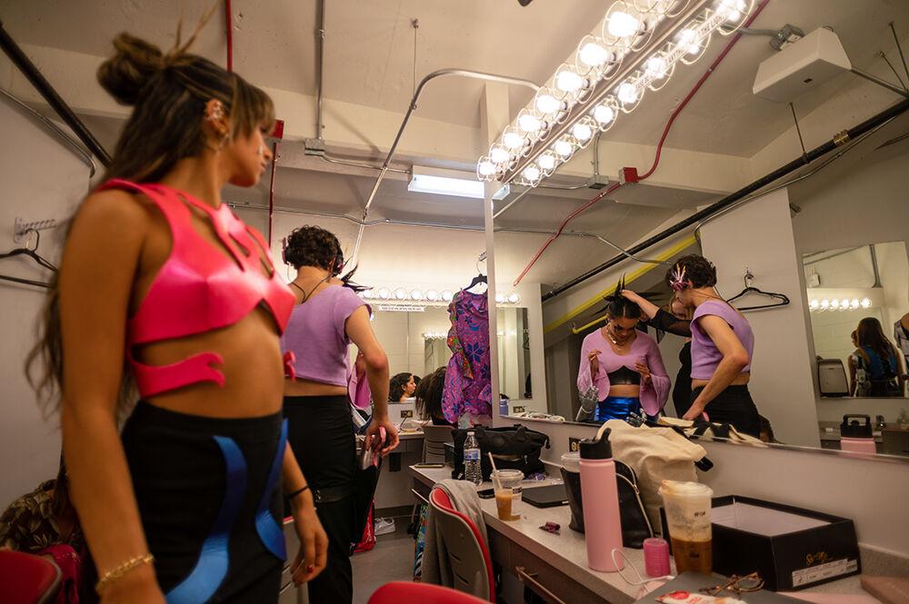 Rachel Gore, a fourth-year studying art and design, does final touch ups to models before the Art2Wear dress rehearsal at Stewart Theatre on Tuesday, April 25, 2023. Gore's collection titled "Wired" focused on the things that make people unique.