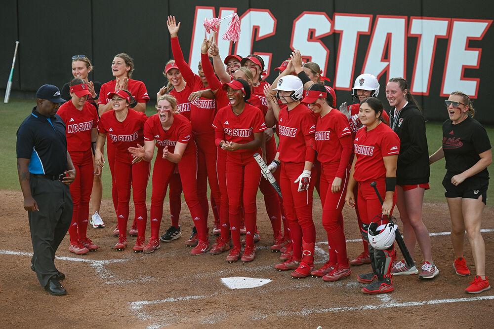 Members of the NC State softball team cheer on one of their players during the game against UNC-Chapel Hill at Dail Softball Stadium on Friday, April 21, 2023. NC State lost to the Tar Heels 5-4.
