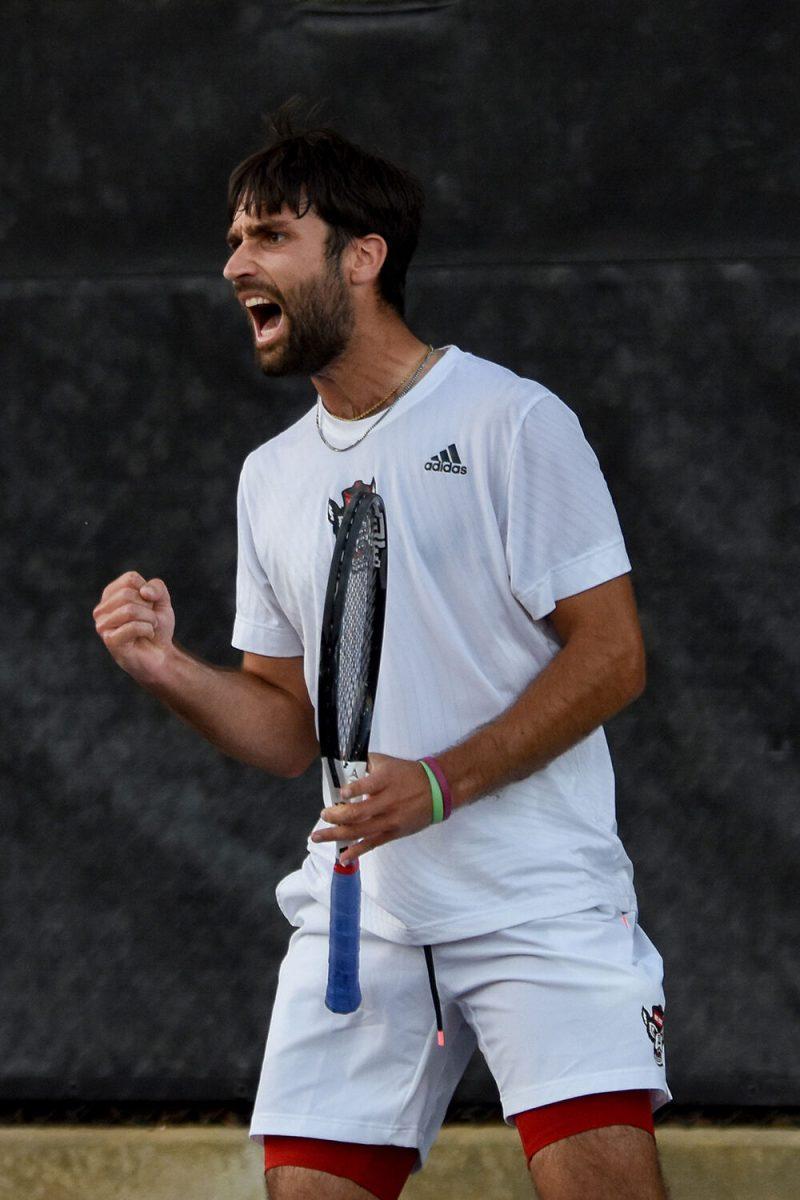 Graduate Rafa Izquierdo Luque yells in celebration during the match against Wake Forest at Dail Outdoor Tennis Stadium on Wednesday, April 12, 2023. Luque won his doubles match. NC State beat Wake Forest 4-2.