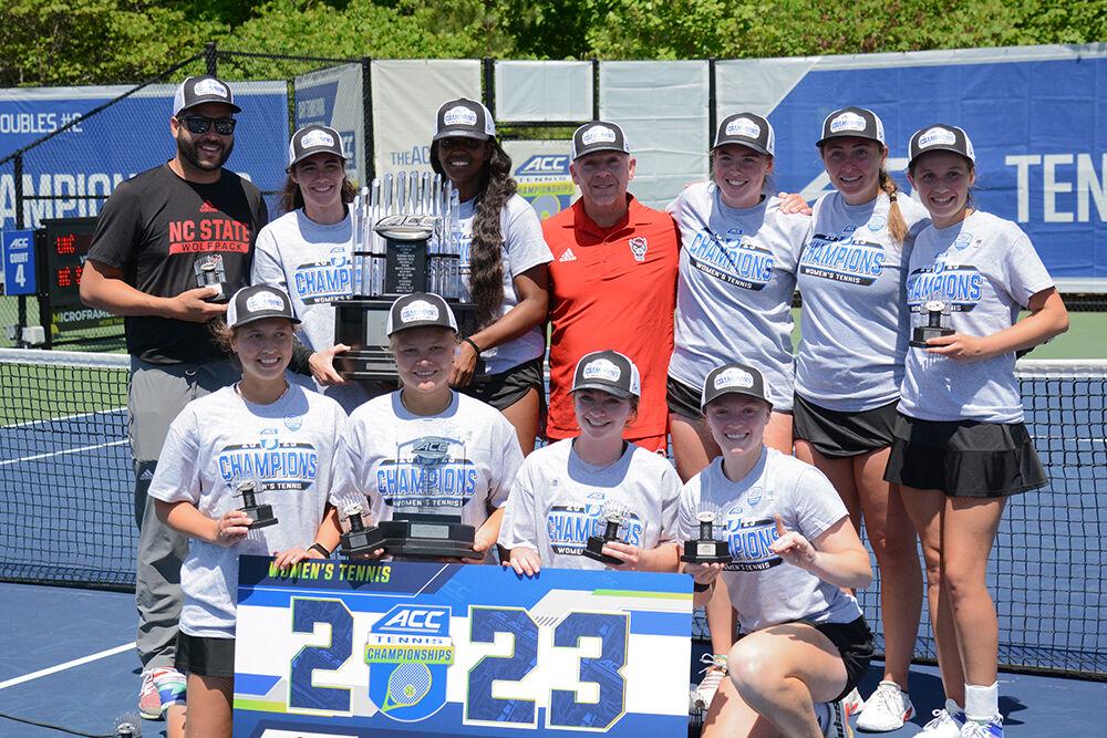 The NC State women's tennis team poses for pictures after winning the 2023 ACC Tennis Championship against the University of North Carolina at Cary Tennis Park on Sunday, April 23, 2023. The Wolfpack defeated the Tar Heels 4-1.