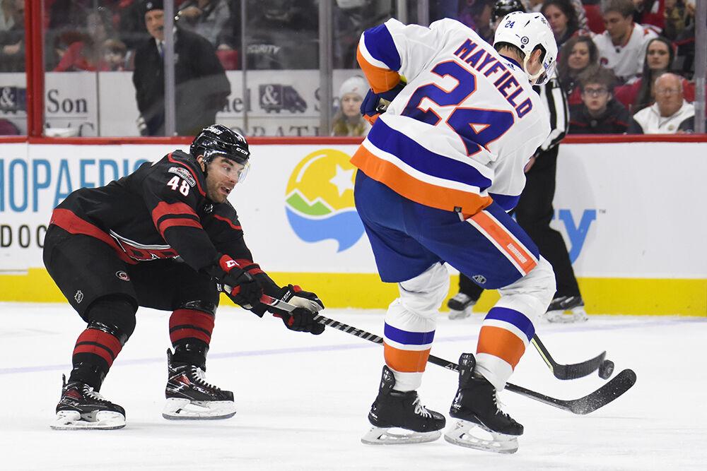 Carolina Hurricanes left wing Jordan Martinook defends a New York Islanders opponent in PNC Arena on Sunday, April 2, 2023. Martinook had one goal and five shots on goal throughout the game. The Hurricanes won 2-1.